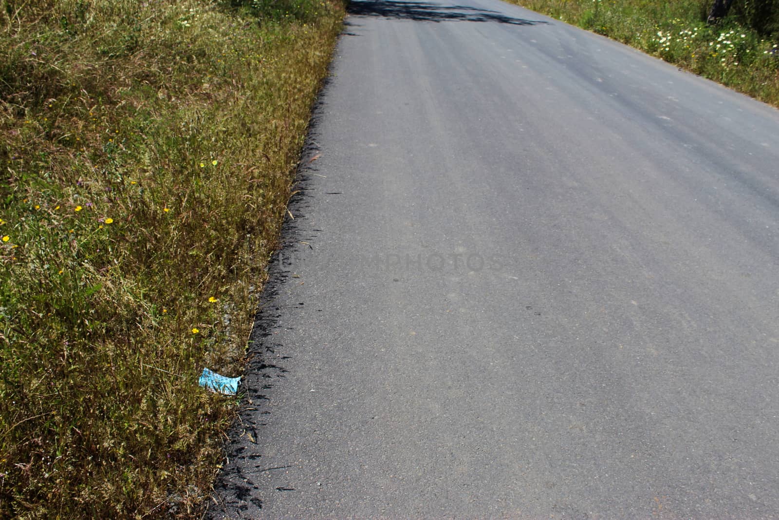 Discarded roadside mask, during Coronavirus. Garbage, environmental pollution. by mahirrov