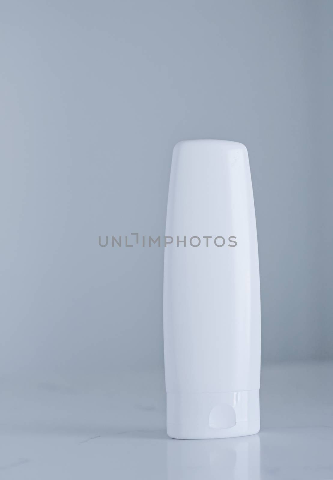 Blank label cosmetic container bottle as product mockup on gray background by Anneleven