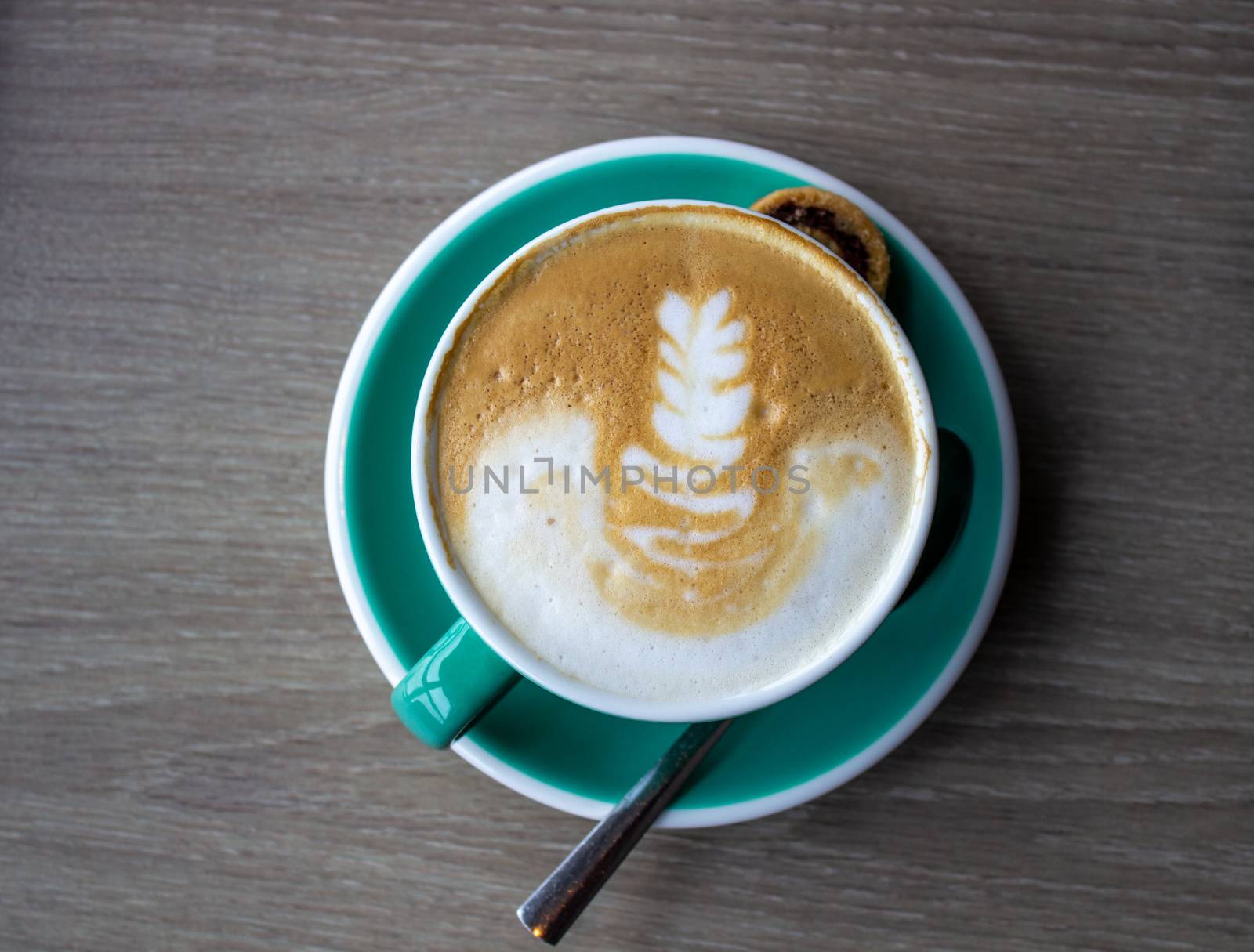 cappuccino cup on the brown wooden table