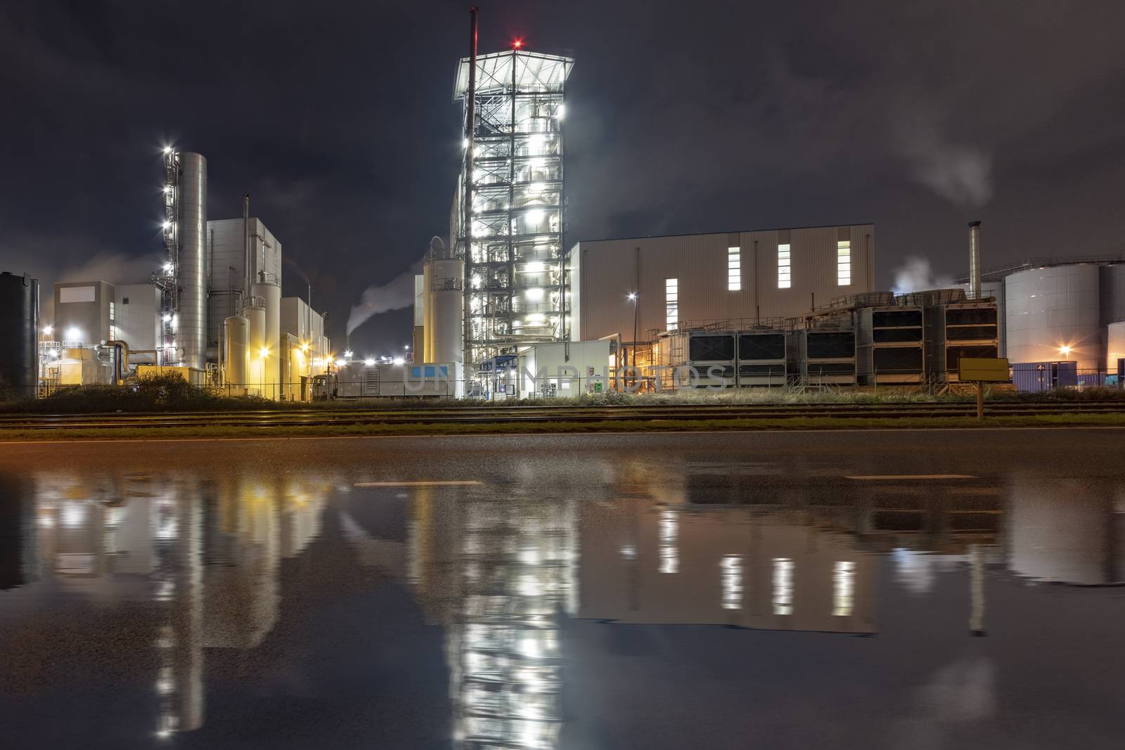 Night view of an industrial zone with the rail road and wed road reflection transporting in and out raw materials to the factories, Netherlands