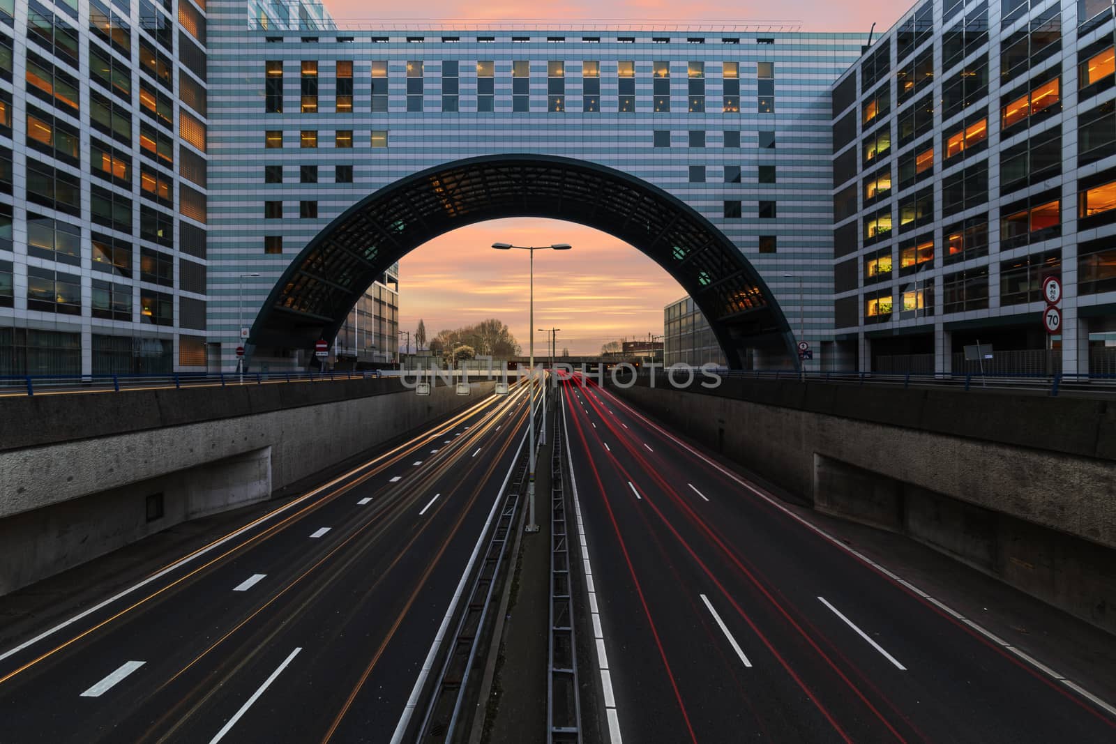 Buildings over the end of A12 highway entering inside The Hague city during the blue hours, Netherlands by ankorlight