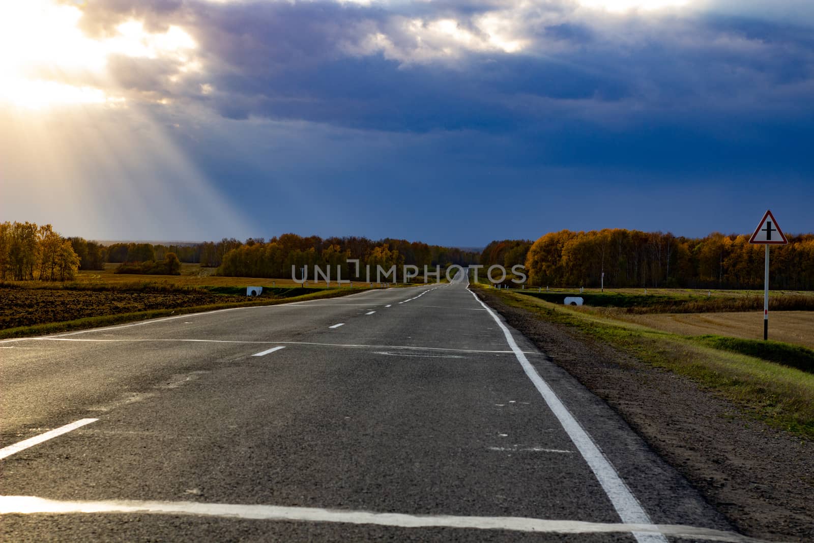 Large paved road in the middle of the field. Greater depth of field