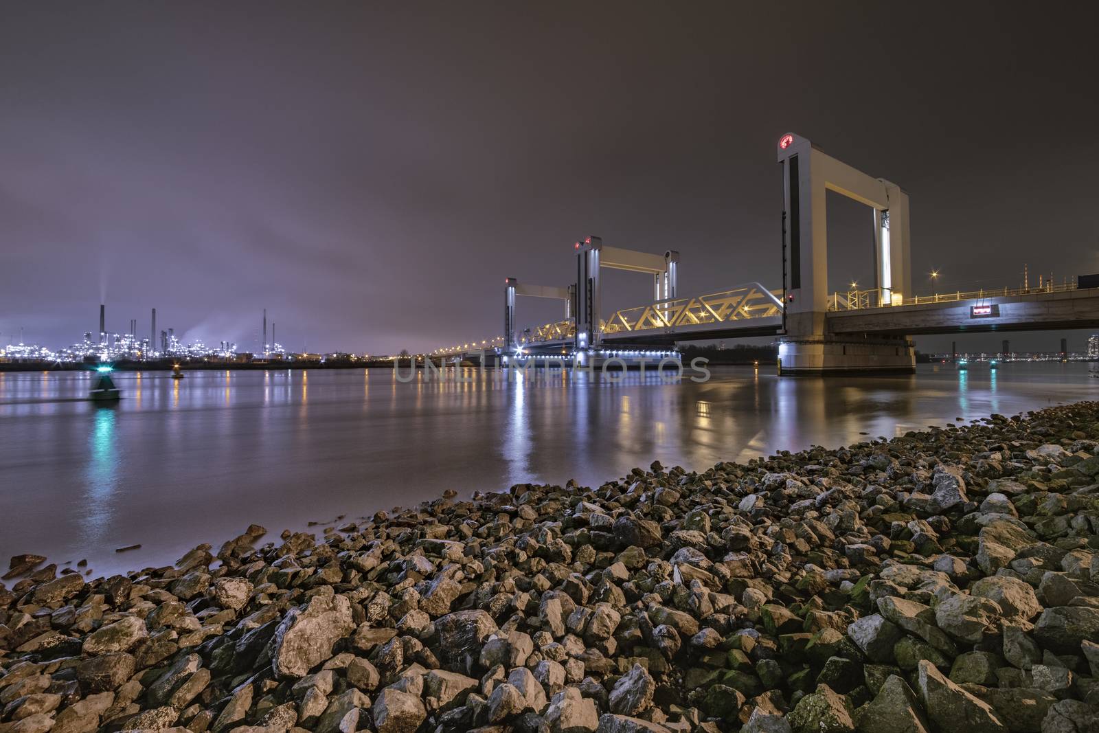 ROTTERDAM, 21 March 2019 - View of the Dutch Betlek bridge over the river and against the Rotterdam chemical industrial complex. by ankorlight