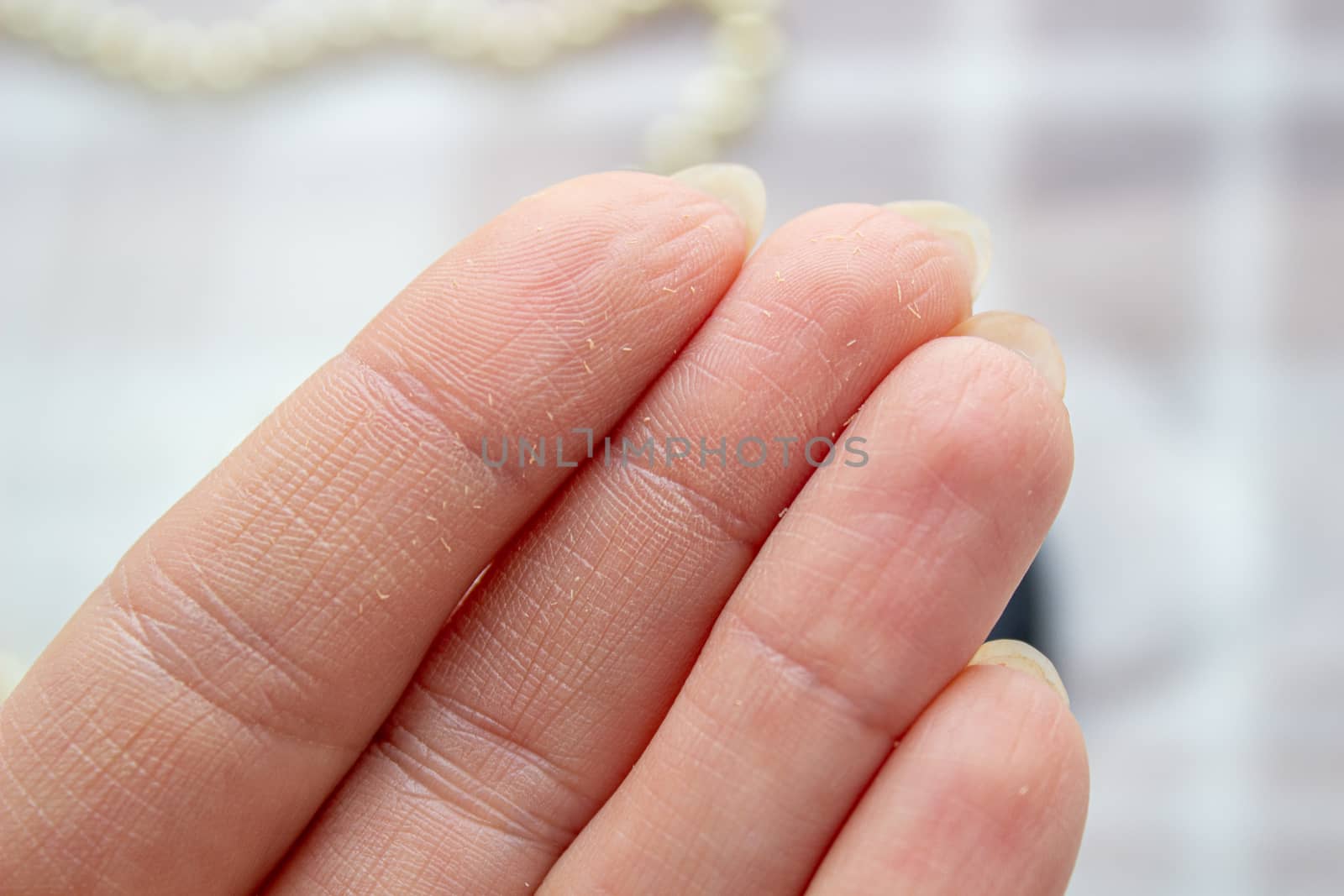 Cosmetic product on the fingers of a woman's hand, close-up