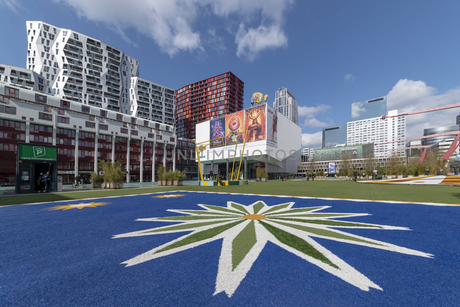 ROTTERDAM, 13 April 2019 - Central place of the cinema building in Rotterdam with the ground decorated with face colored grass depicting a twelve branched star