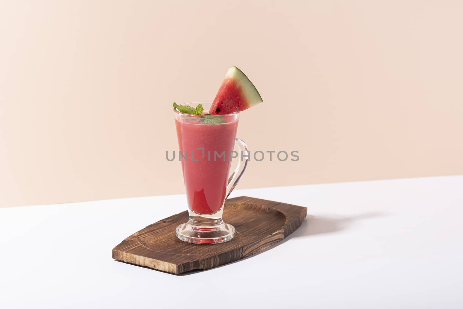 Fresh water melon juice and watermelon slice on color background. summer drink.