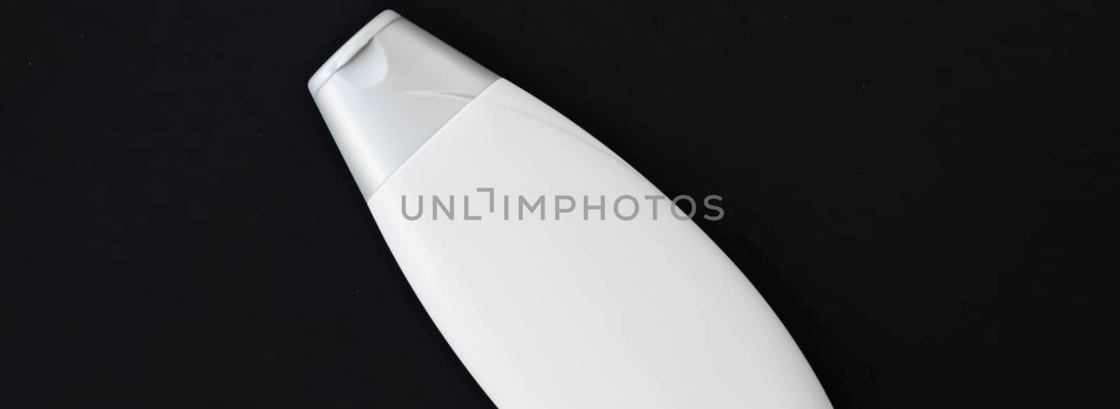 Blank label cosmetic container bottle as product mockup on black background, hygiene and healthcare