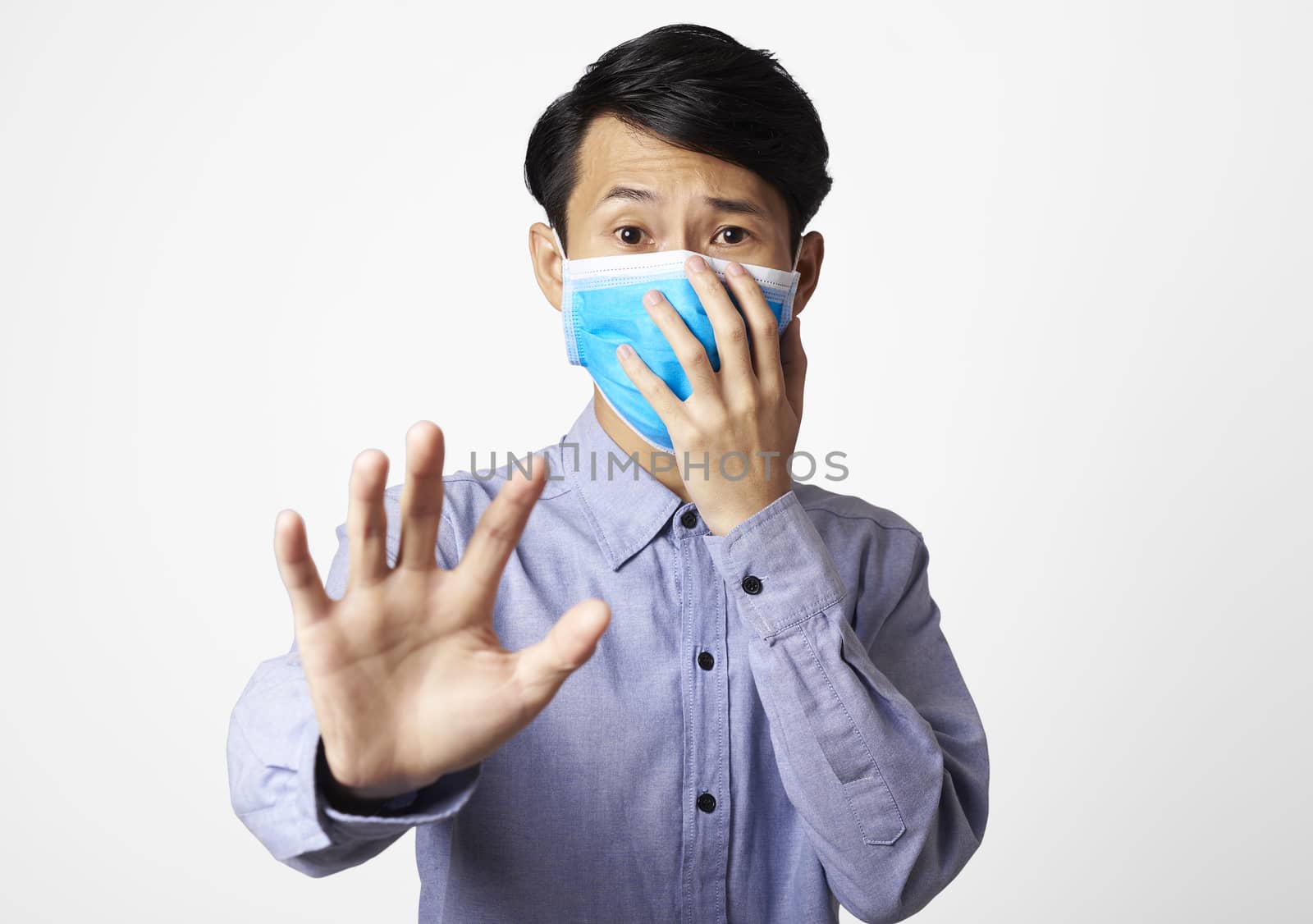 Asia man panic disorder wearing surgical mask covering mouth and nose. epidemic corona virus protection.