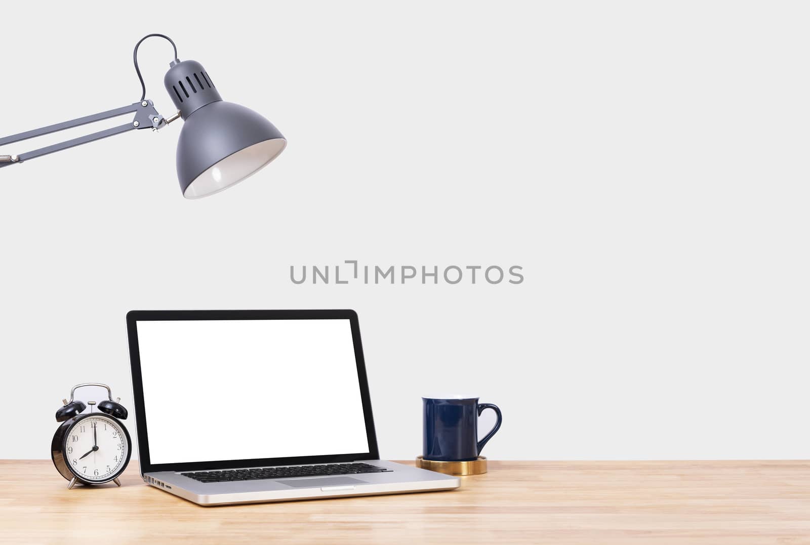 Mockup Blank screen notebook computer and decorations on wood table and white wall background.