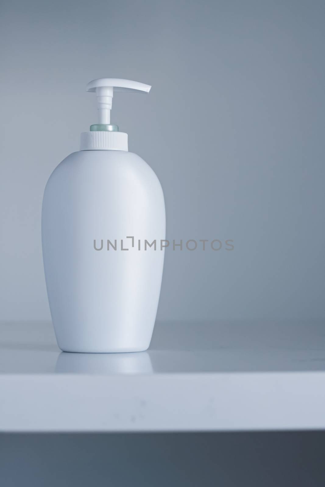 Blank label cosmetic container bottle as product mockup on gray background, hygiene and healthcare