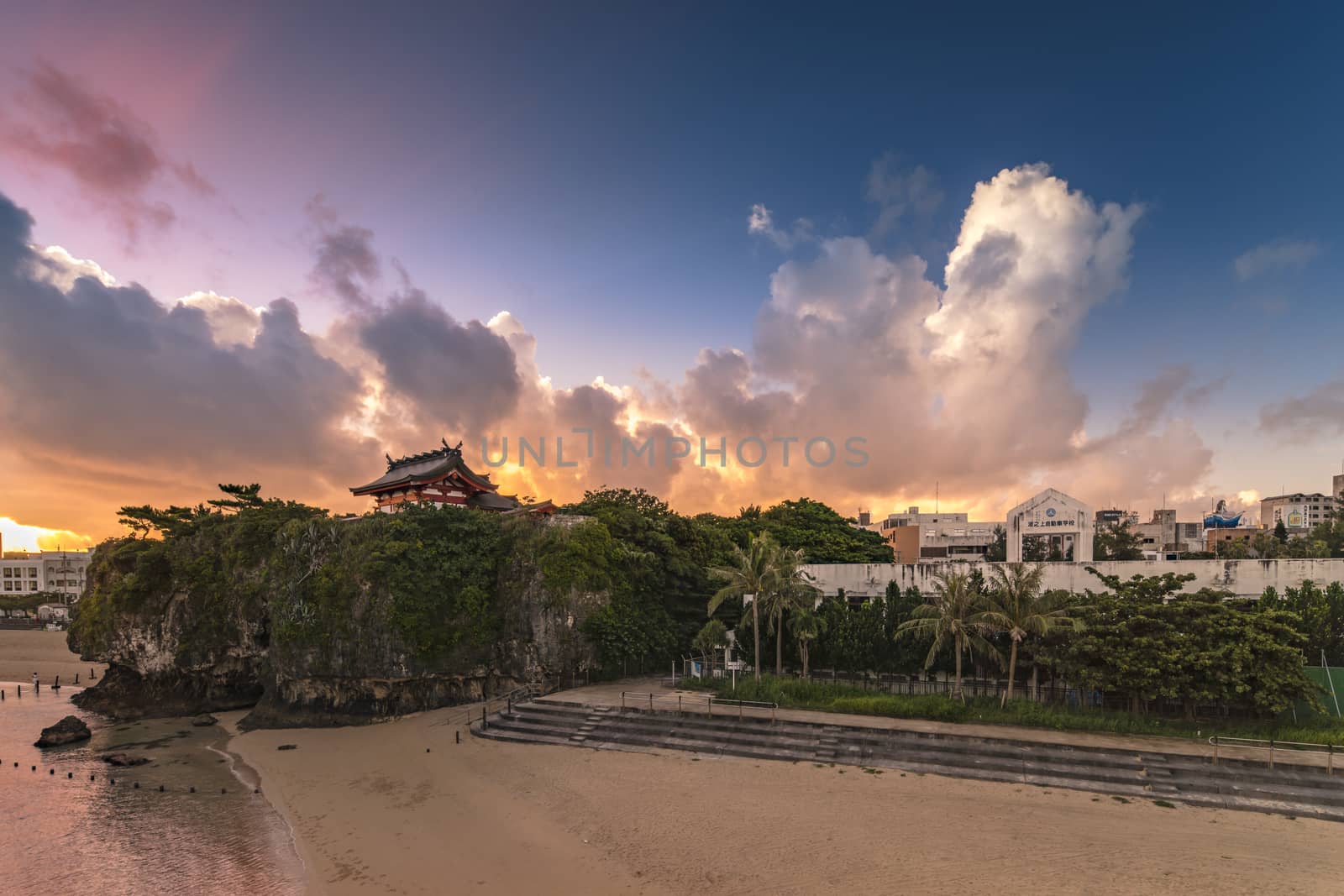 Sunrise landscape of the Shinto Shrine Naminoue at the top of a cliff overlooking the beach and ocean of Naha in Okinawa Prefecture, Japan.