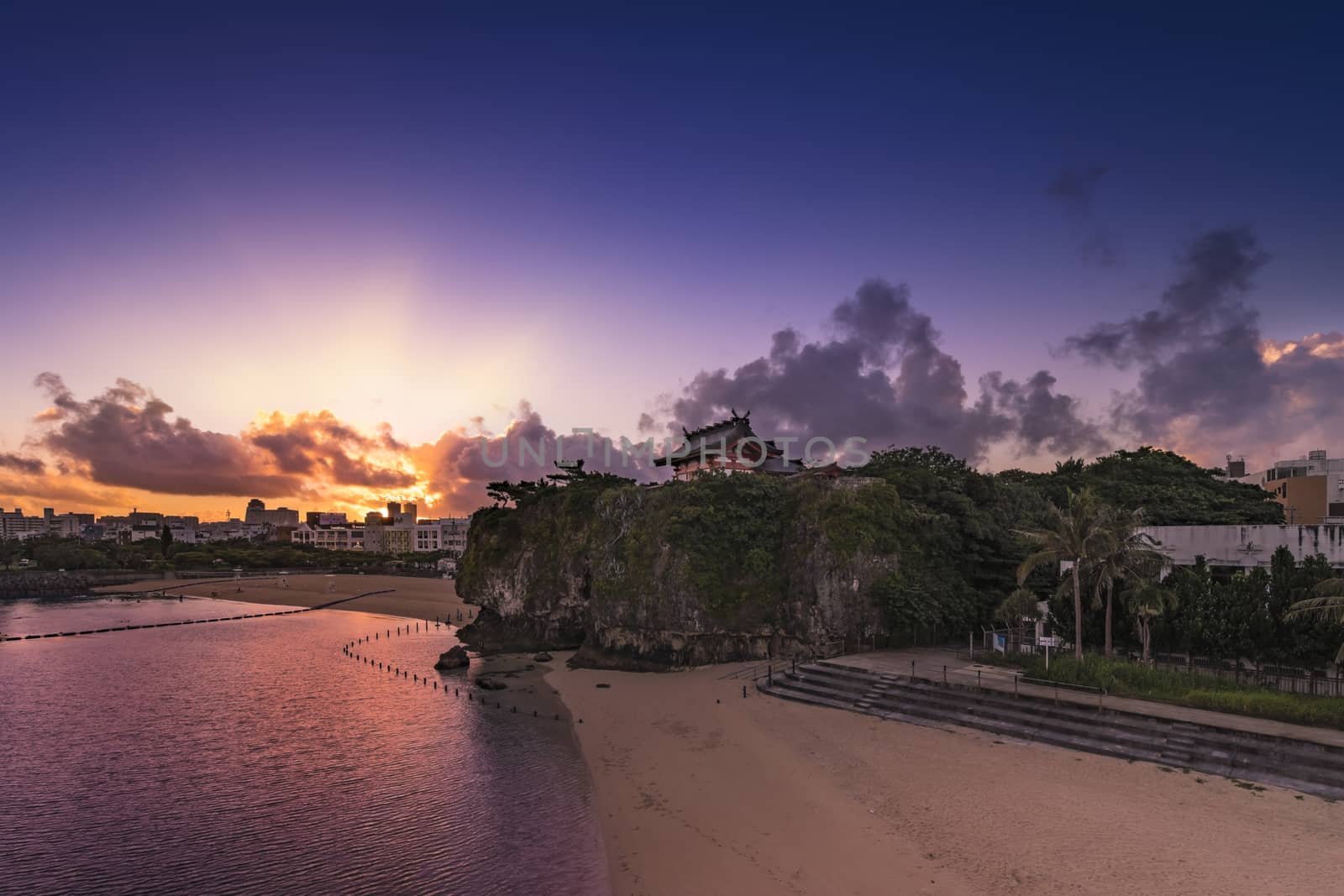 Sunrise landscape of the Shinto Shrine Naminoue at the top of a cliff overlooking the beach and ocean of Naha in Okinawa Prefecture, Japan.