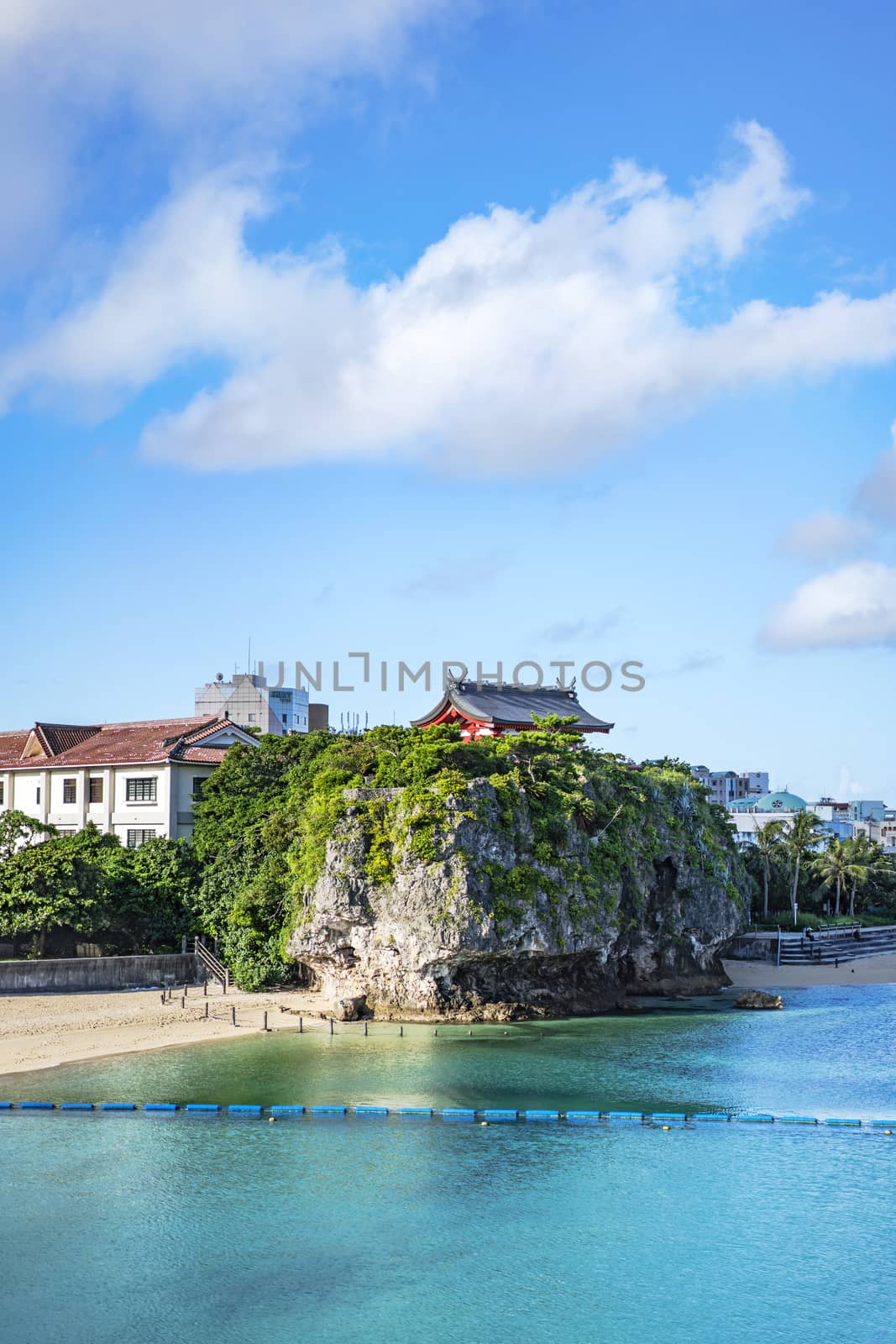 Summer landscape of the Shinto Shrine Naminoue at the top of a cliff overlooking the beach and ocean of Naha in Okinawa Prefecture, Japan.