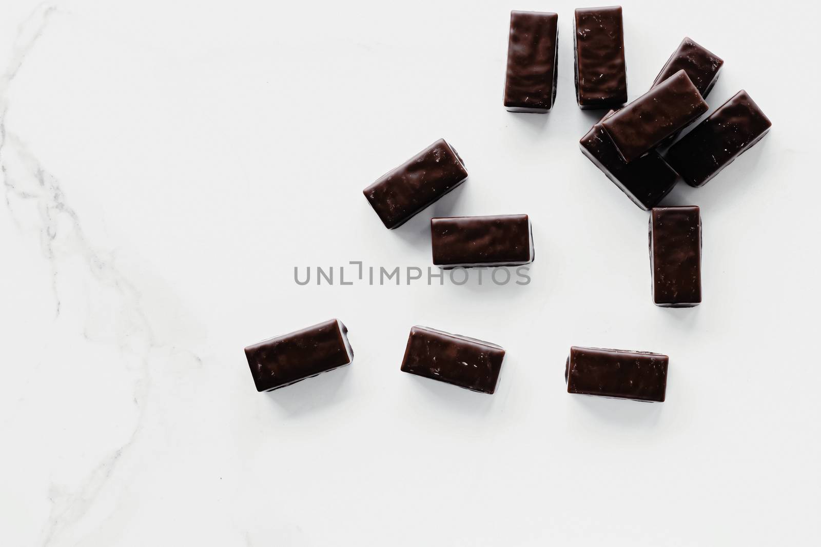 Dark chocolate candies isolated on white background, sweet food and dessert by Anneleven