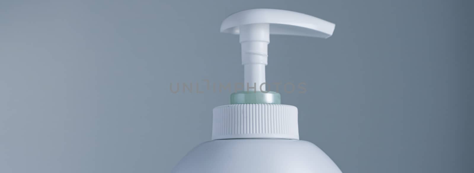 Blank label cosmetic container bottle as product mockup on gray background by Anneleven