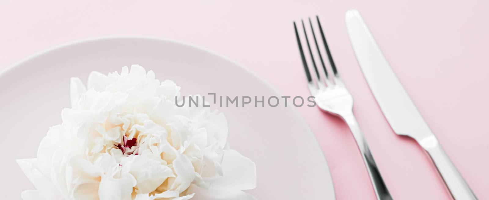 Dining plate and cutlery with peony flower as wedding decor set on pink background, top tableware for event decoration and dessert menu by Anneleven