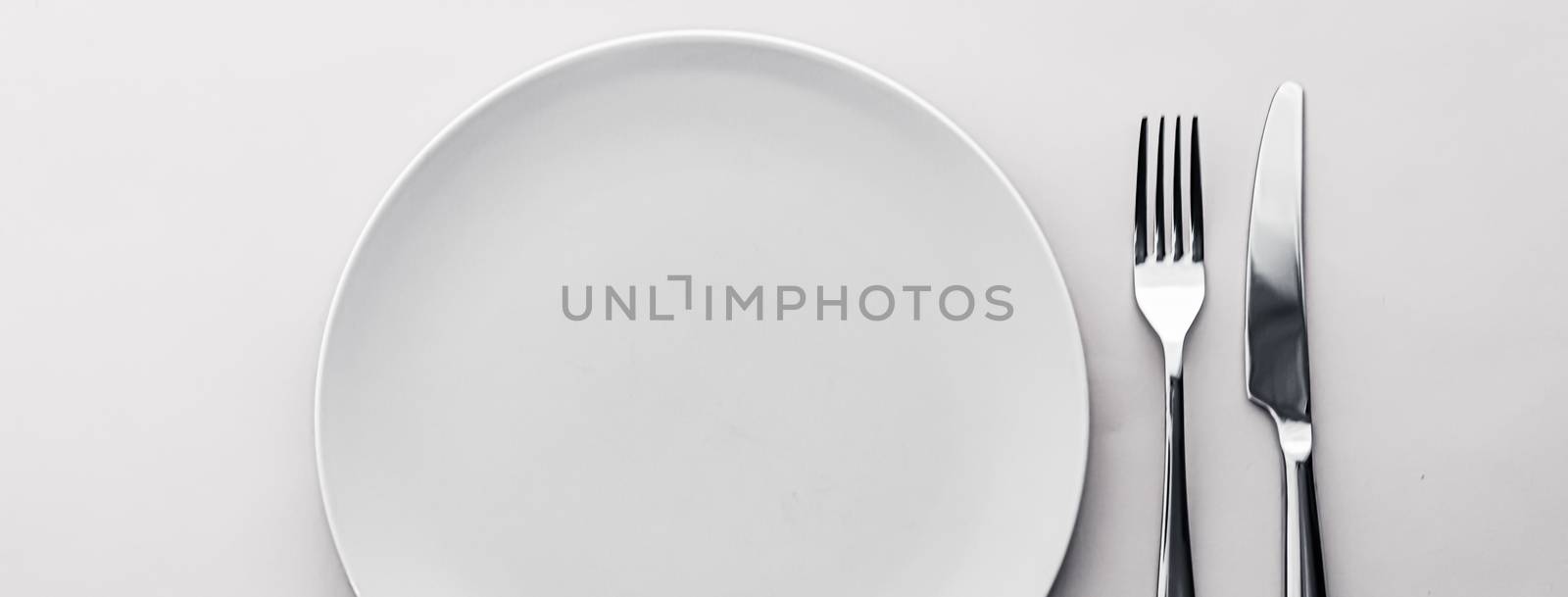 Empty plate and cutlery as mockup set on white background, top tableware for chef table decor and menu branding design