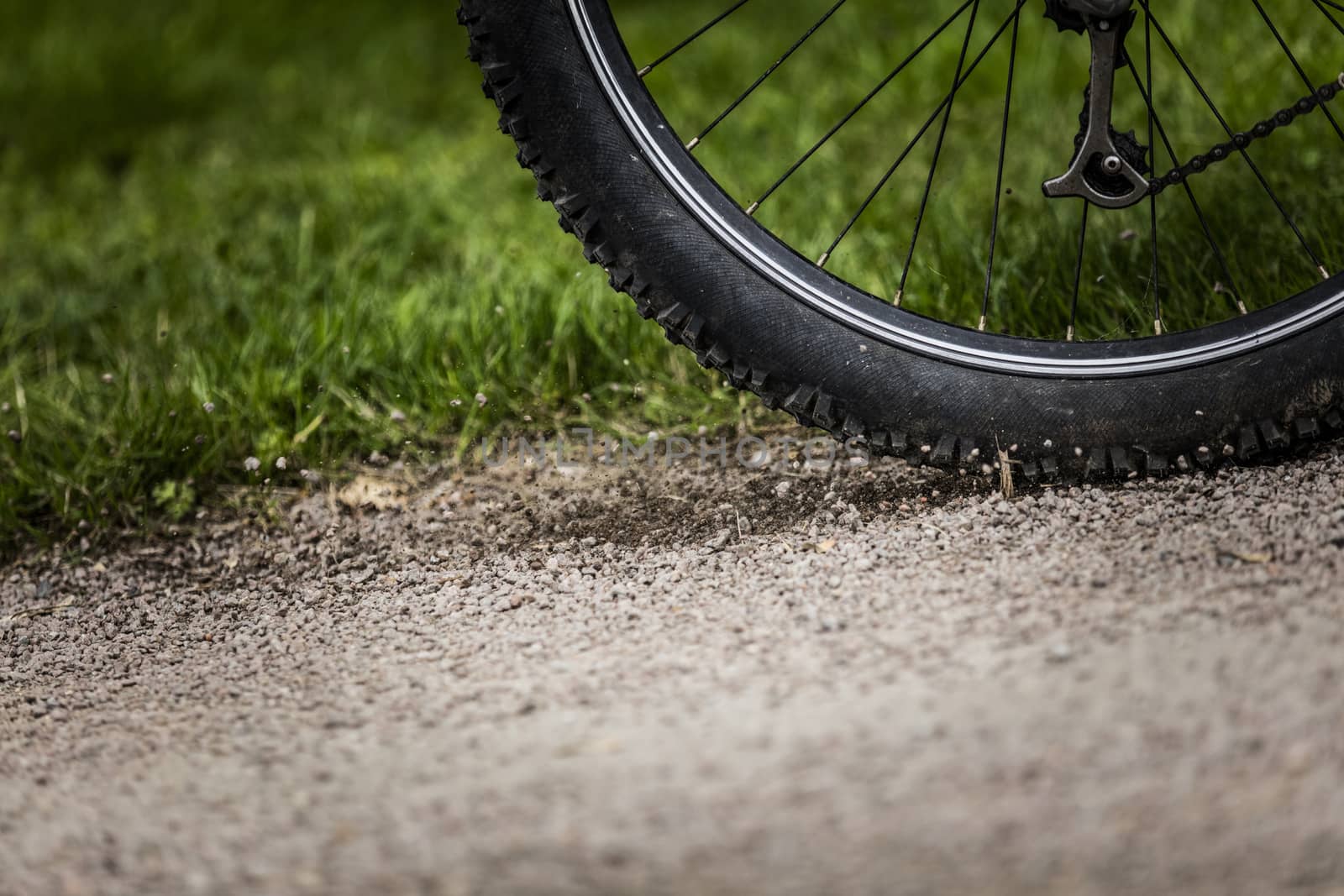 Tealby, Lincolnshire, UK, July 2017, Bike tire kicking up stones