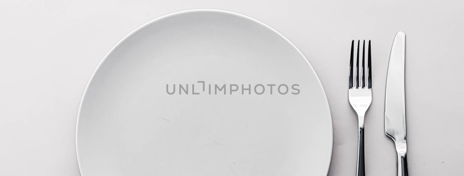 Empty plate and cutlery as mockup set on white background, top tableware for chef table decor and menu branding by Anneleven