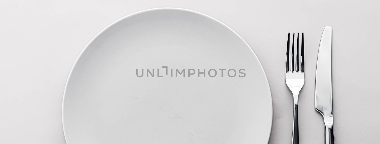 Empty plate and cutlery as mockup set on white background, top tableware for chef table decor and menu branding design