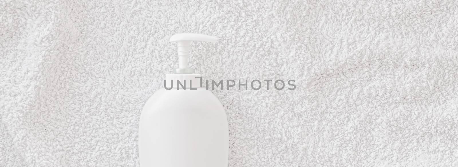 Blank label cosmetic container bottle as product mockup on white towel background by Anneleven