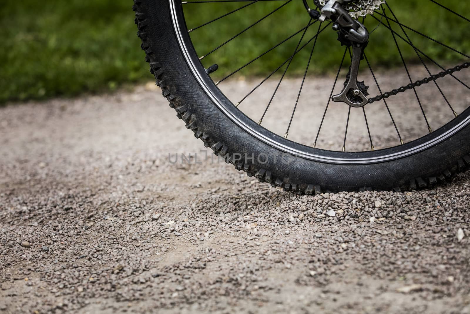 Tealby, Lincolnshire, UK, July 2017, Bike tire kicking up stones