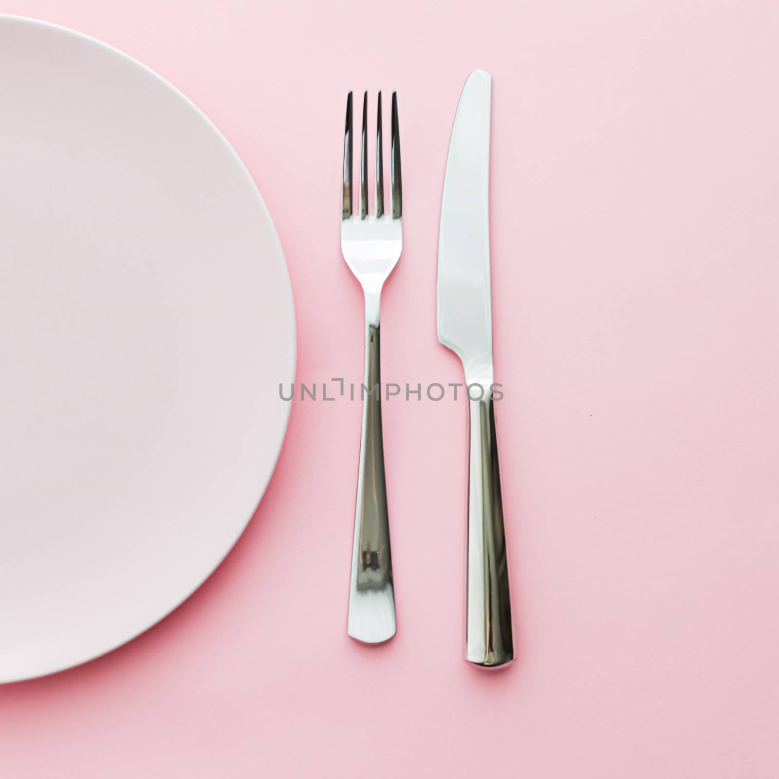 Empty plate and cutlery as mockup set on pink background, top tableware for chef table decor and menu branding by Anneleven