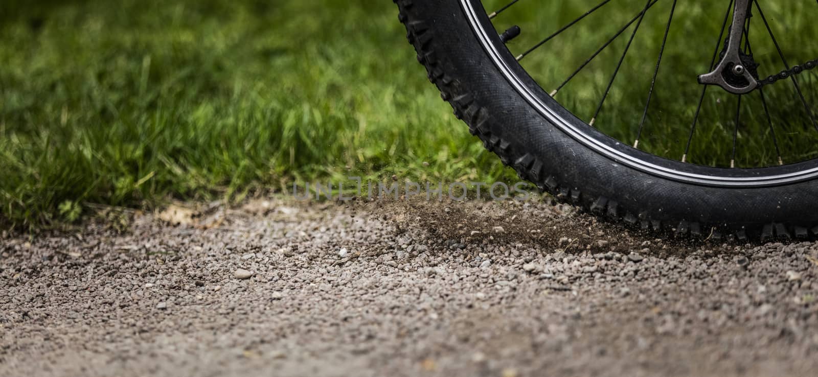 Tealby, Lincolnshire, UK, July 2017, Bike tire kicking up stones