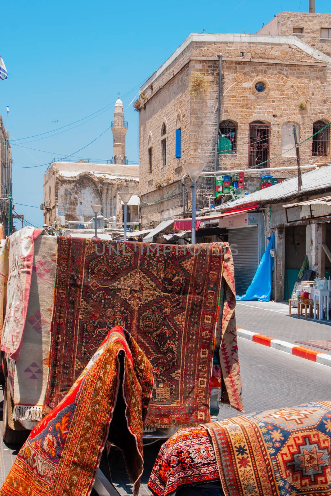 Alley with carpet store in the old city of Jaffa by RnDmS