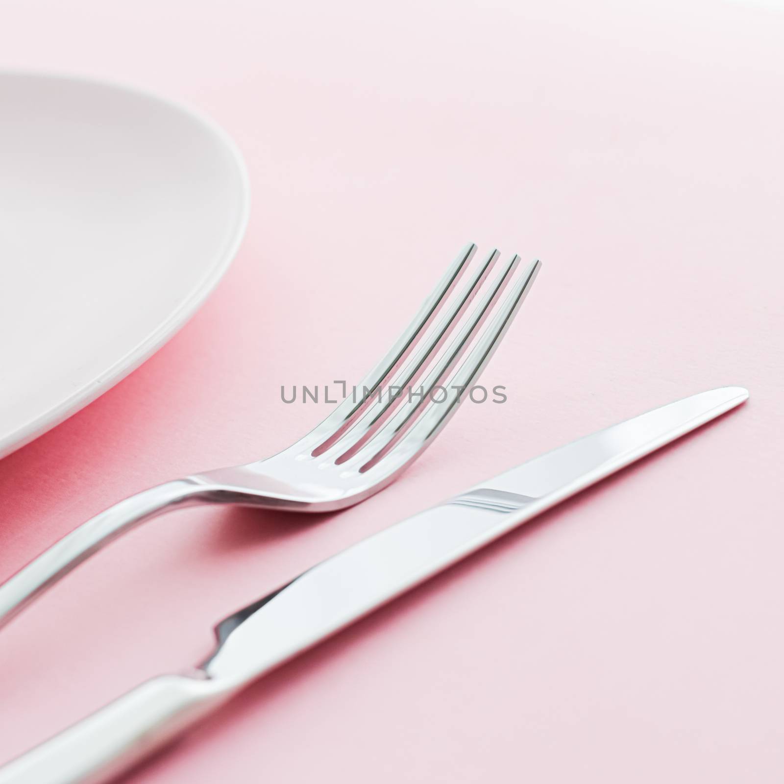 Empty plate and cutlery as mockup set on pink background, top tableware for chef table decor and menu branding by Anneleven