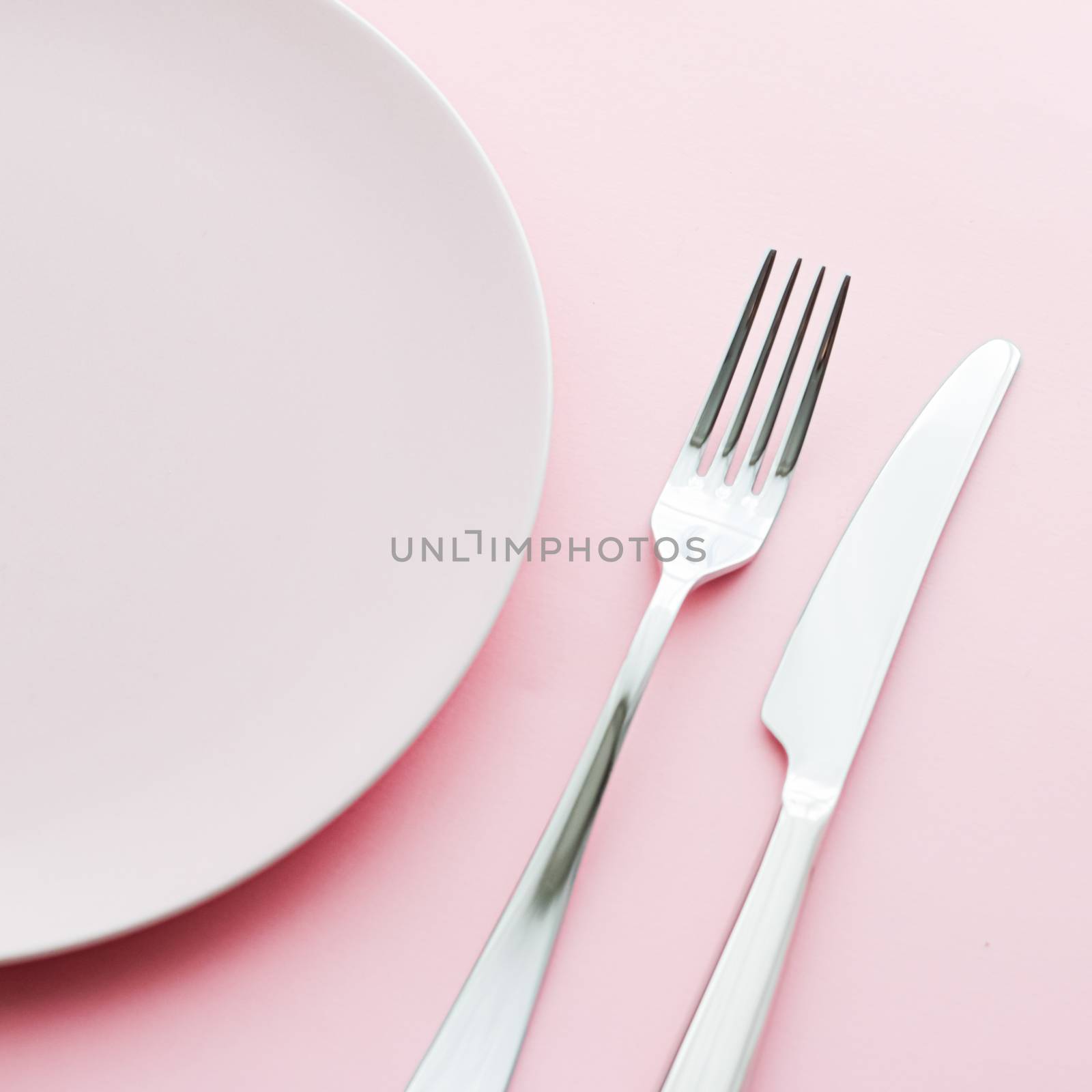 Empty plate and cutlery as mockup set on pink background, top tableware for chef table decor and menu branding by Anneleven