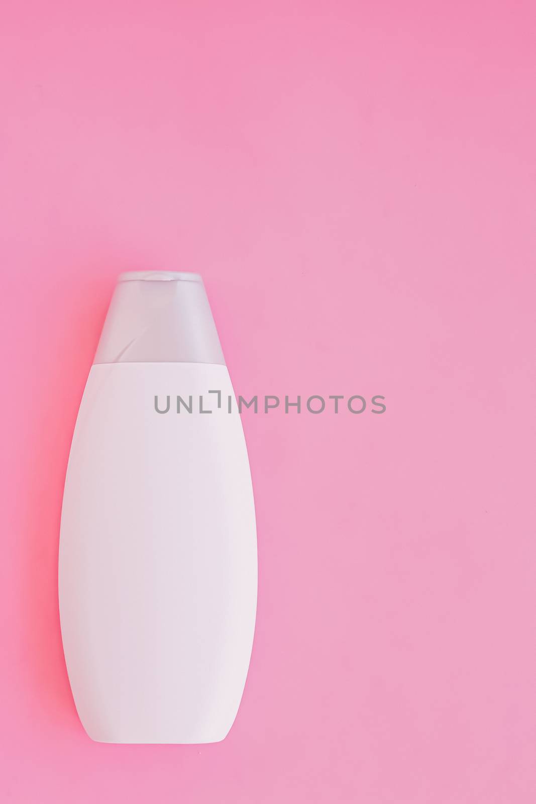 Blank label shampoo bottle or shower gel on pink background, beauty product and body care cosmetics, flatlay