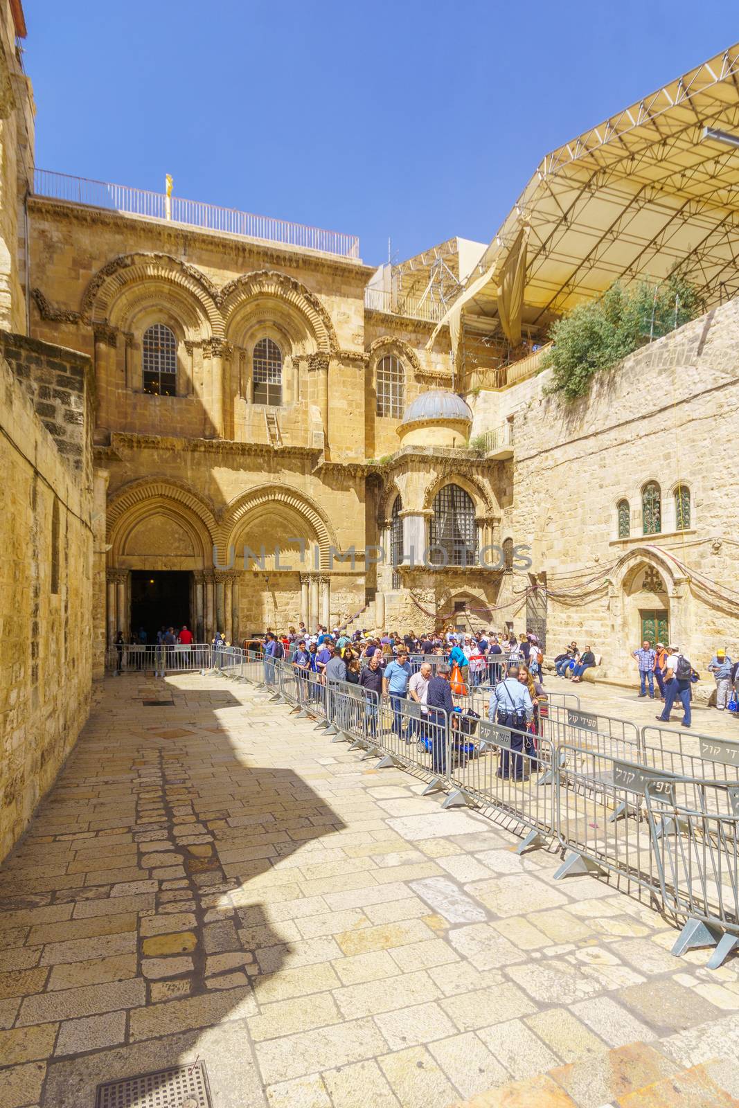 Jerusalem, Israel - April 6, 2018: Orthodox good Friday scene in the entry yard of the church of the holy sepulcher, with pilgrims. The old city of Jerusalem, Israel