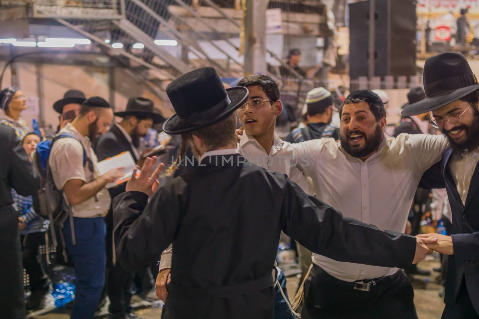 MERON, ISRAEL - MAY 03, 2018: Orthodox Jewish men attend and dance, at the annual hillula of Rabbi Shimon Bar Yochai, in Meron, Israel, on Lag BaOmer Holiday