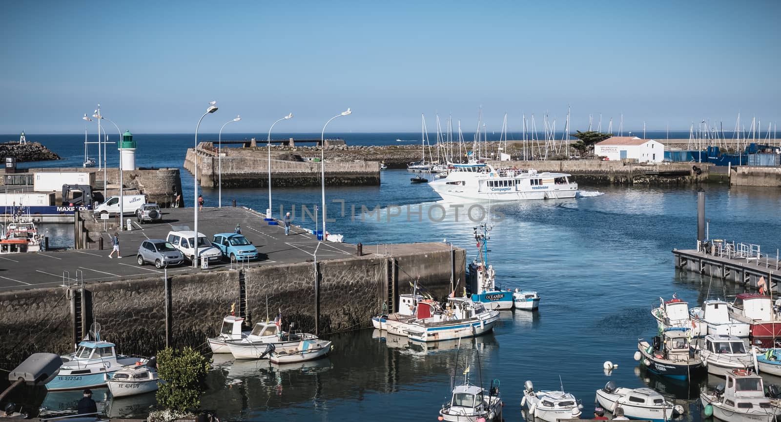 Port Joinville on the island of Yeu - September 17, 2018: view of the small port where maneuver fishing boats, tourism boats and sea shuttles going to the mainland on a summer day