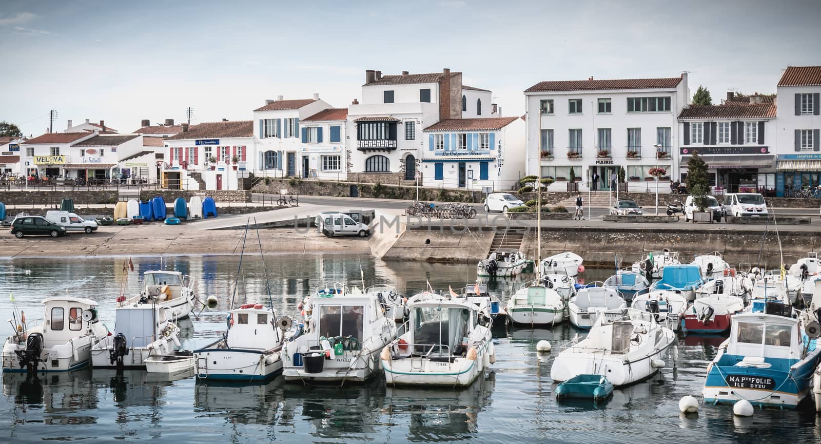 Port Joinville on the island of Yeu - September 17, 2018: view of the small port where maneuver fishing boats, tourism boats and sea shuttles going to the mainland on a summer day