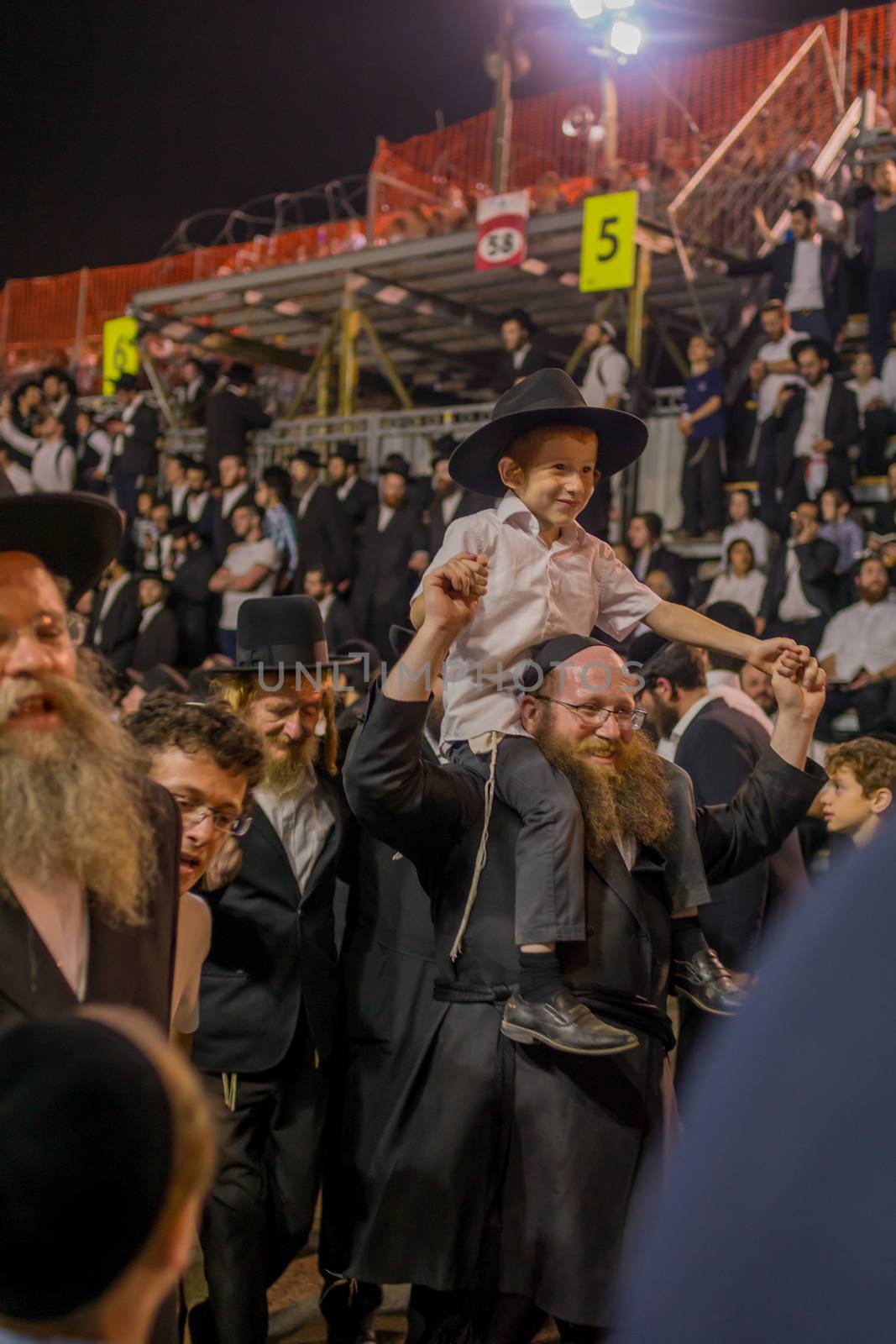 MERON, ISRAEL - MAY 03, 2018: Orthodox Jewish men attend and dance, at the annual hillula of Rabbi Shimon Bar Yochai, in Meron, Israel, on Lag BaOmer Holiday