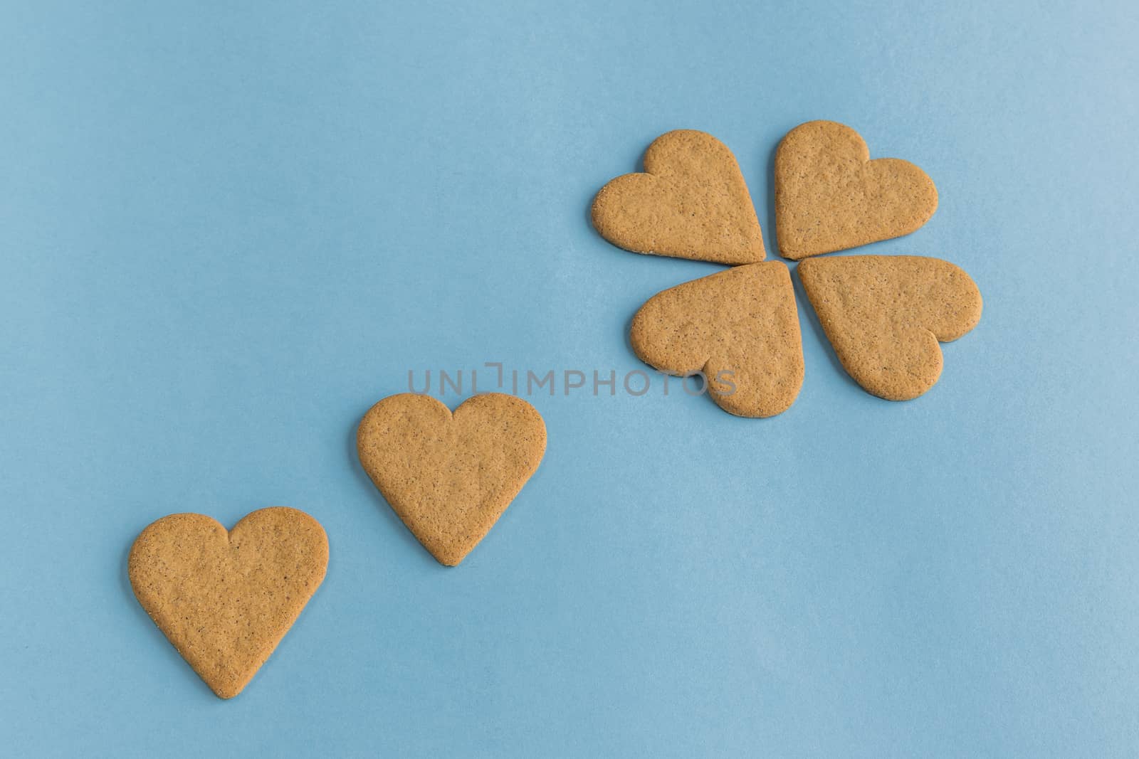 Breakfast. Close-up of heart shaped cookies like a flower petals.. Blue background. Copy space