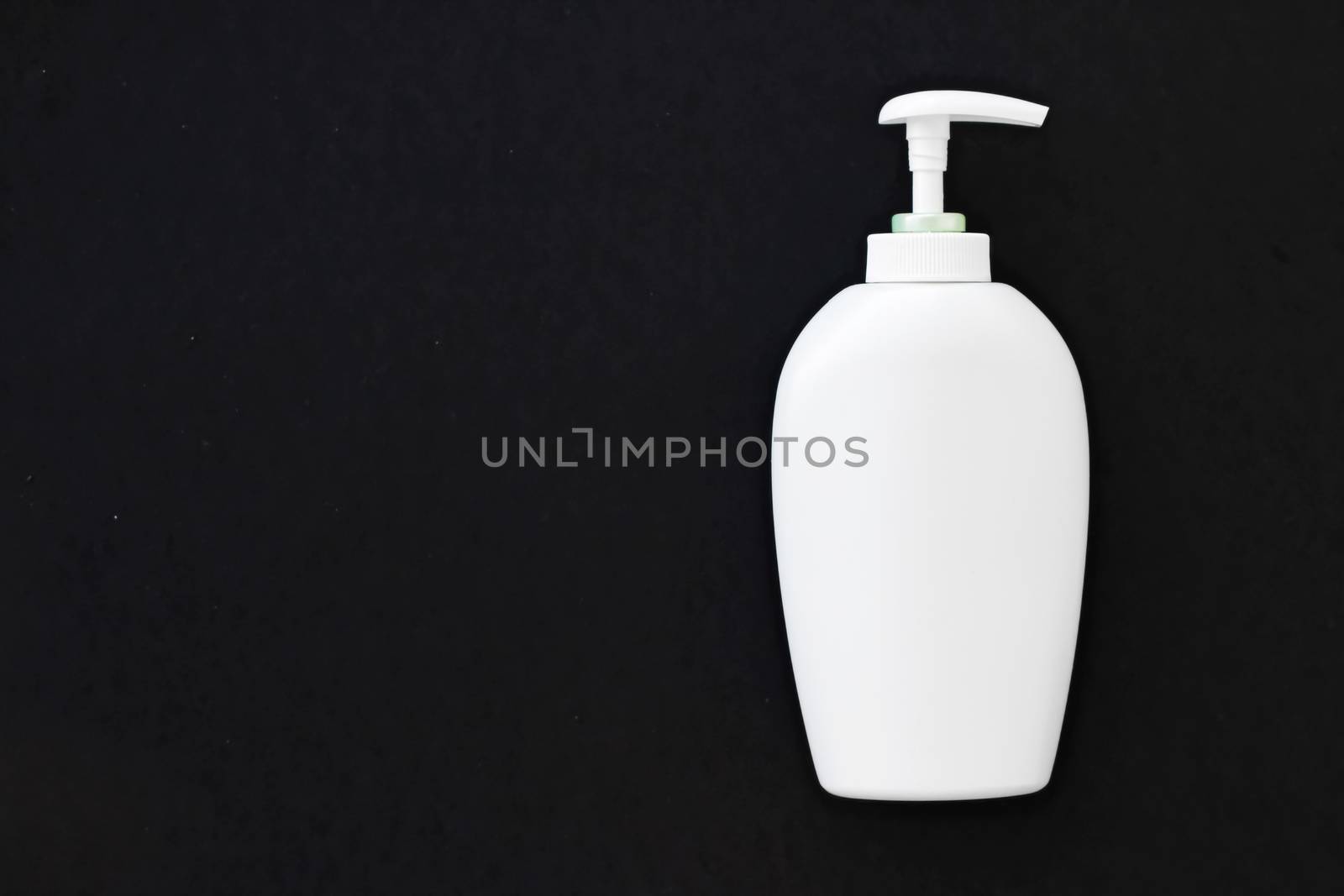 Blank label cosmetic container bottle as product mockup on black background, hygiene and healthcare