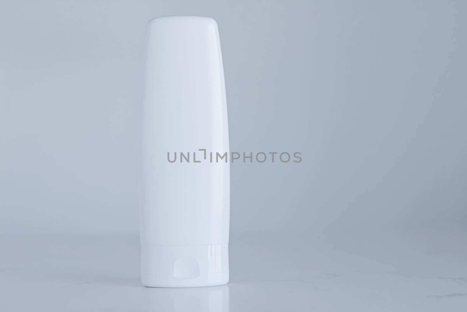 Blank label cosmetic container bottle as product mockup on gray background by Anneleven