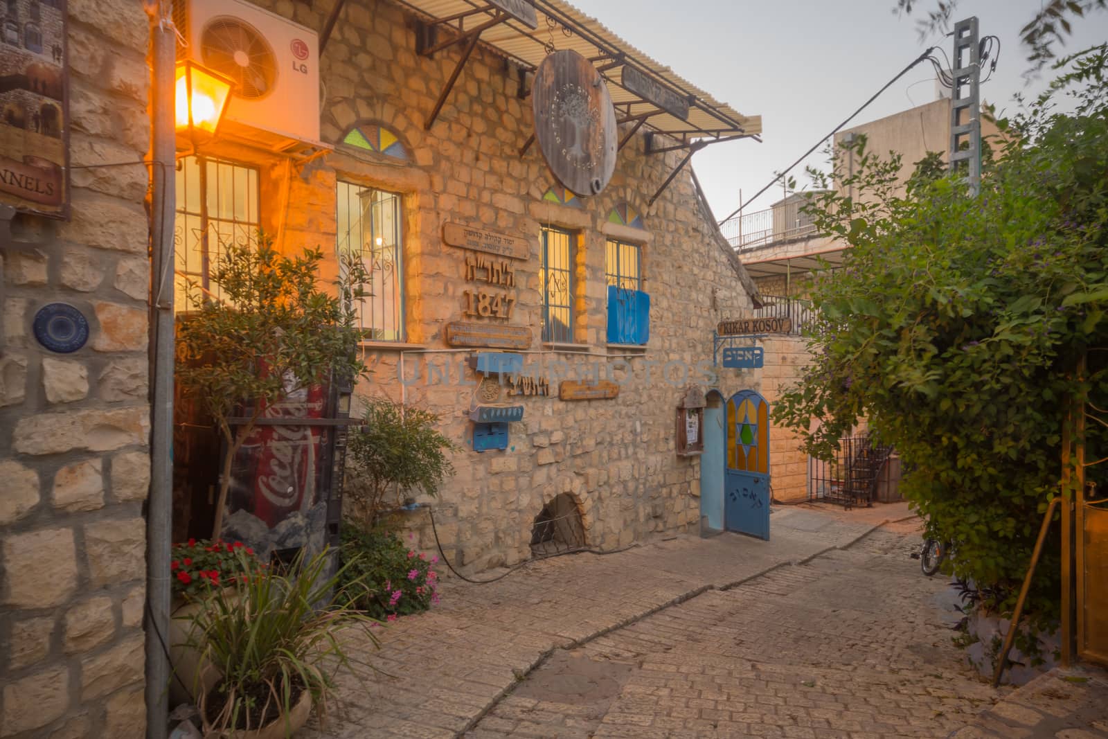 SAFED, ISRAEL - SEPTEMBER 14, 2016: An alley in the Jewish quarter of the old city, with various signs, in Safed (Tzfat), Israel