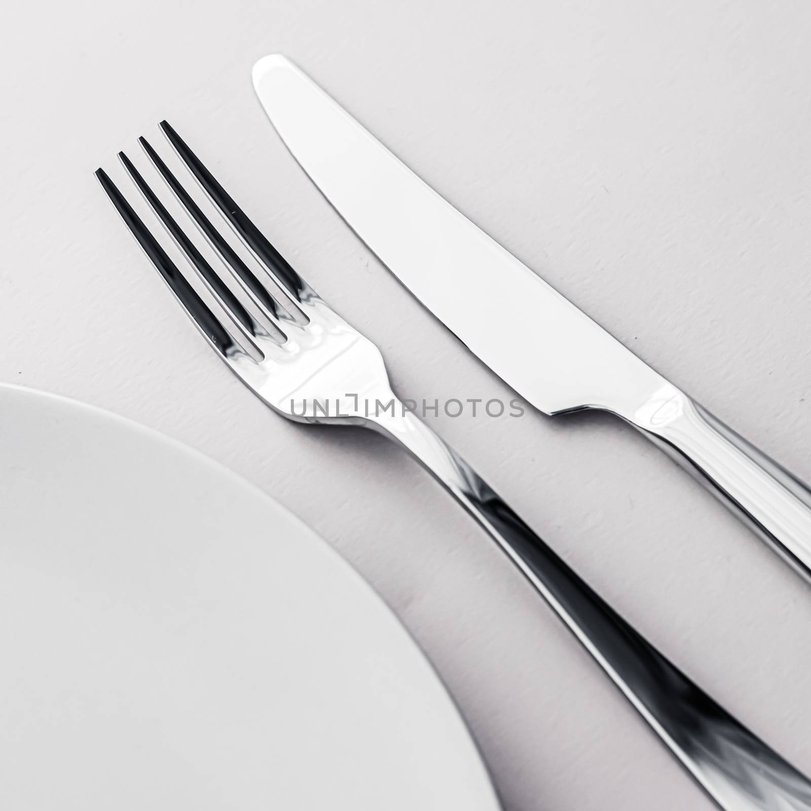 Empty plate and cutlery as mockup set on white background, top tableware for chef table decor and menu branding by Anneleven