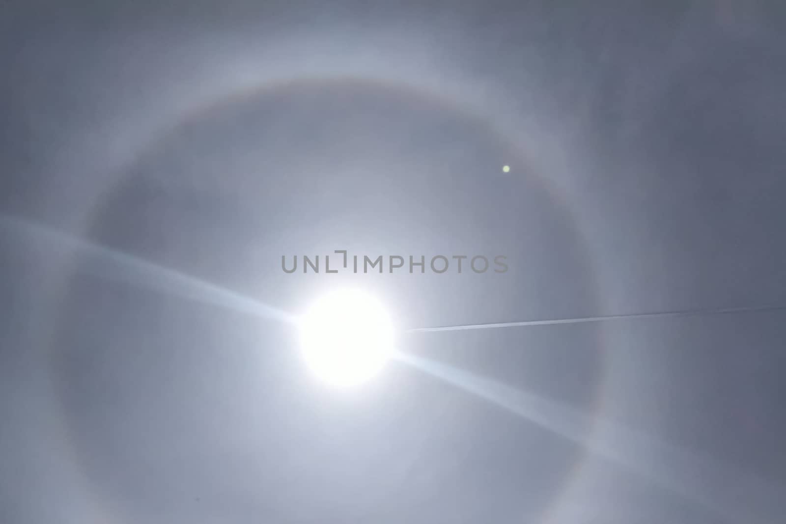 The phenomenon of halo in the sky. A rare natural phenomenon. Three halo suns. The plane flies through the halo.