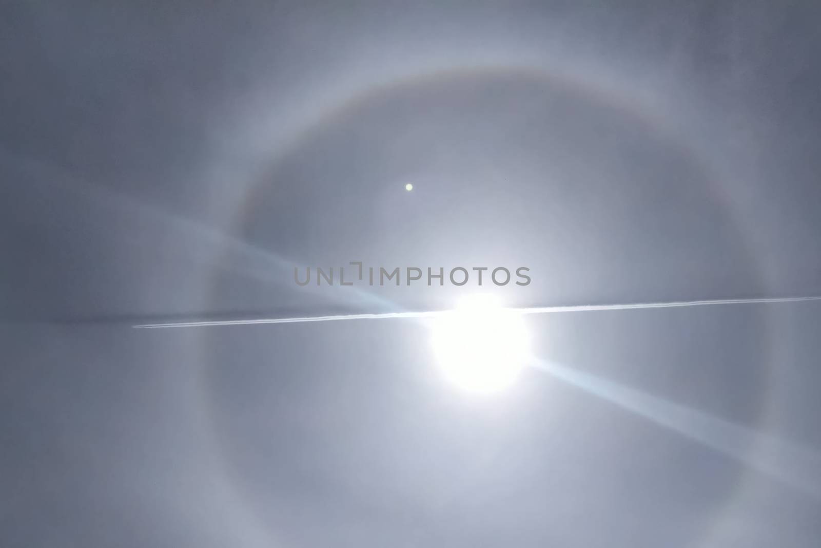 The phenomenon of halo in the sky. A rare natural phenomenon. Three halo suns. The plane flies through the halo.