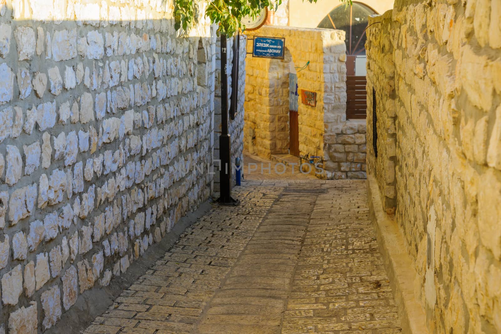 SAFED, ISRAEL - SEPTEMBER 14, 2016: An alley in the Jewish quarter of the old city, with the Abuhav Synagogue sign, in Safed (Tzfat), Israel