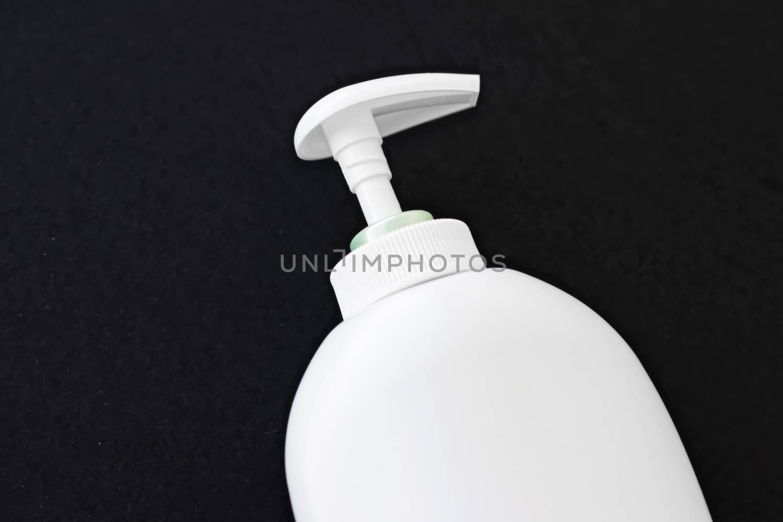 Blank label cosmetic container bottle as product mockup on black background, hygiene and healthcare