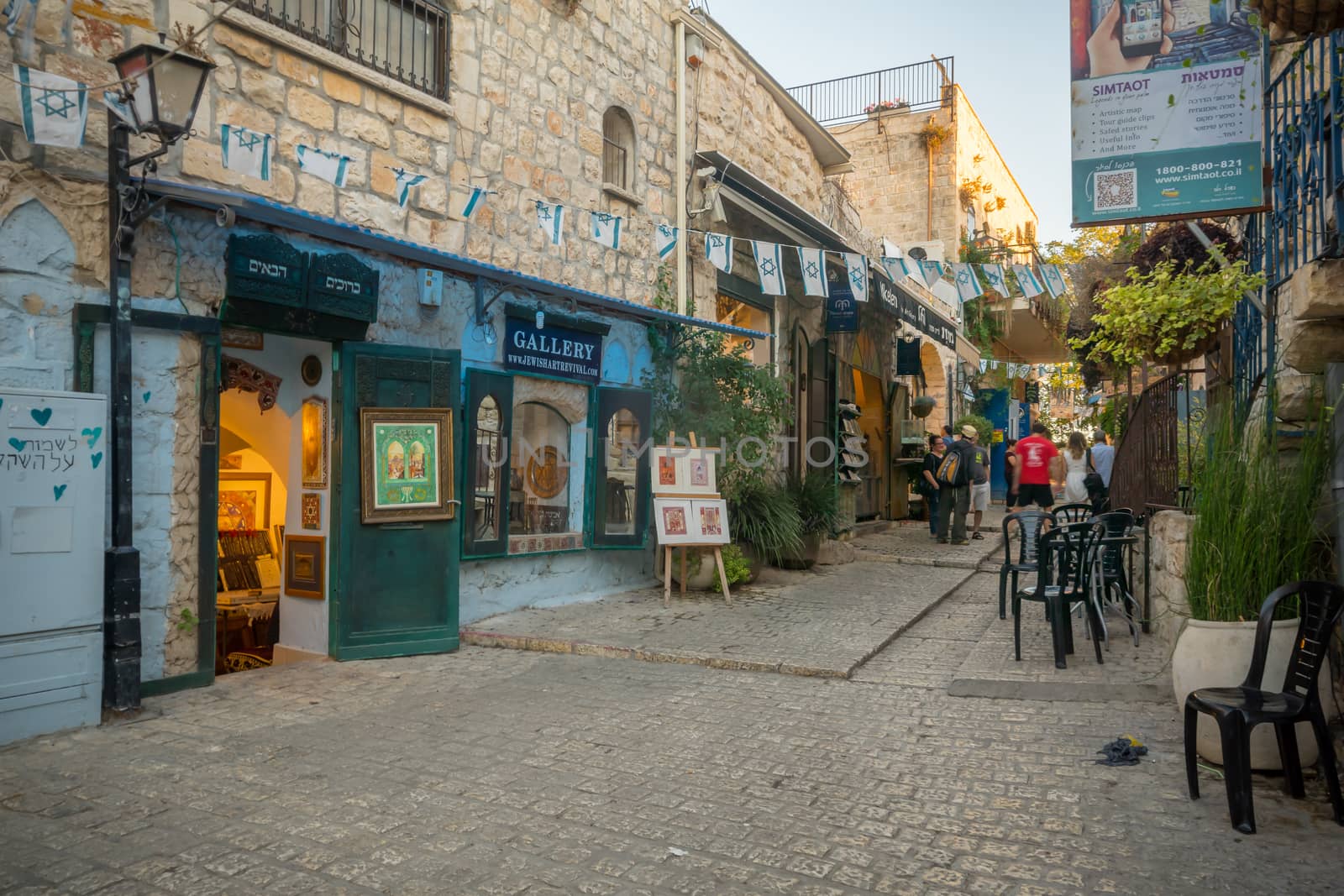SAFED, ISRAEL - SEPTEMBER 14, 2016: Scene in an alley in the Jewish quarter, with local businesses and galleries, locals and visitors, in Safed (Tzfat), Israel