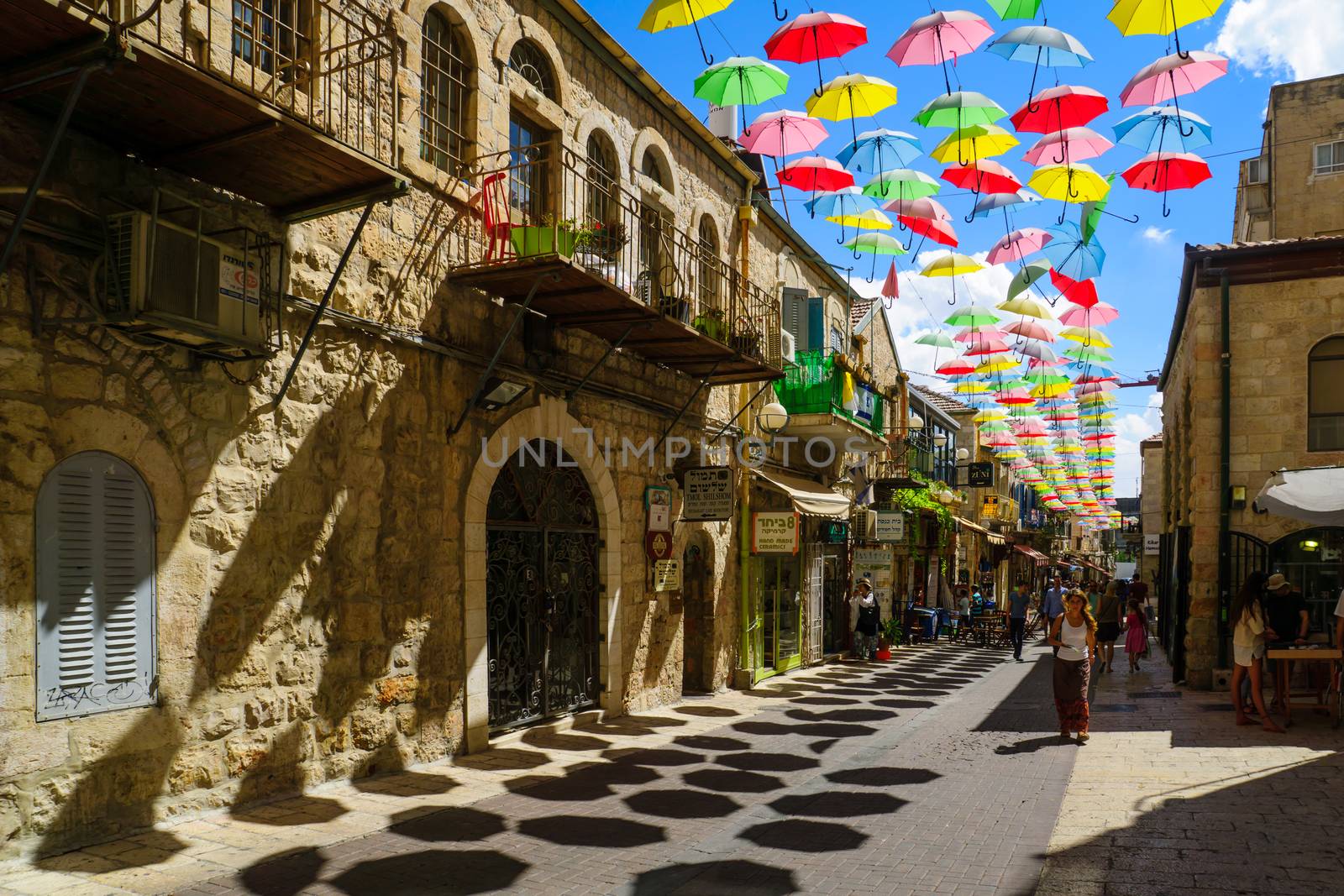 JERUSALEM, ISRAEL - SEPTEMBER 23, 2016: Scene of Yoel Moshe Solomon Street, decorated with colorful umbrellas, with locals and visitors, in the historic Nachalat Shiva district, Jerusalem, Israel