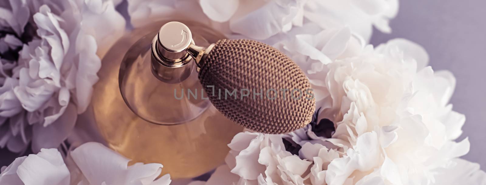 Luxe fragrance bottle as vintage perfume product on violet background and peony flowers, parfum ad and beauty branding design