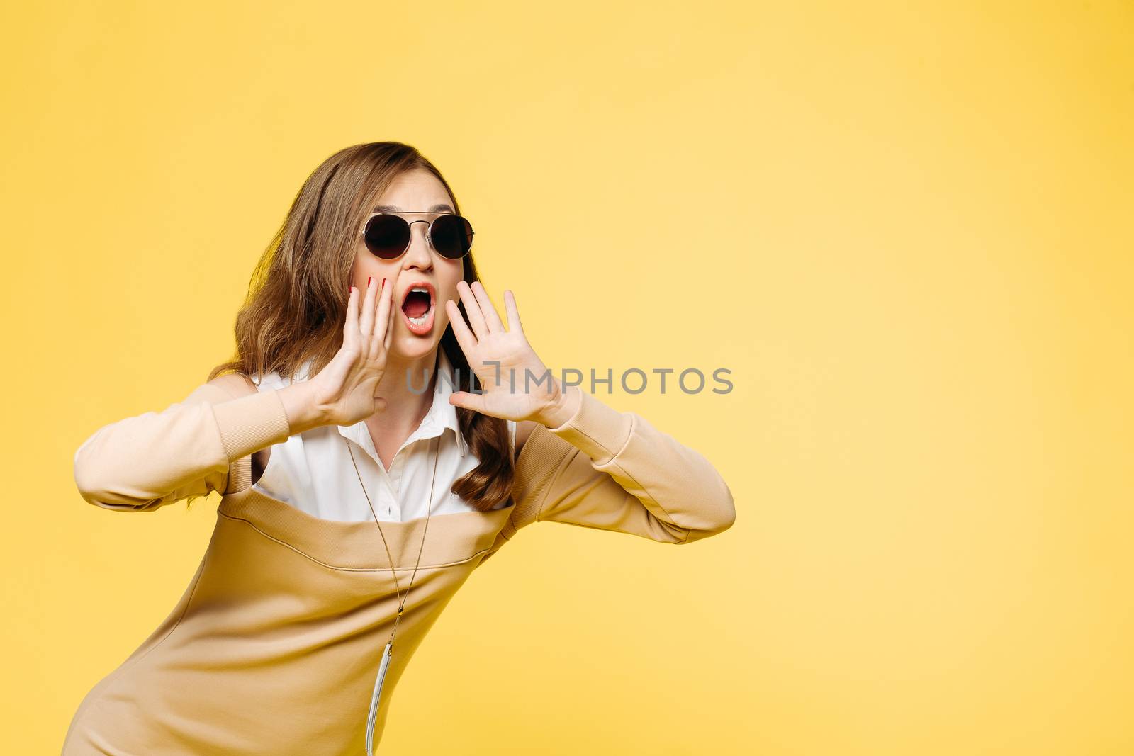 Emotionally brunette woman in sunglasses shouting and screaming. by StudioLucky